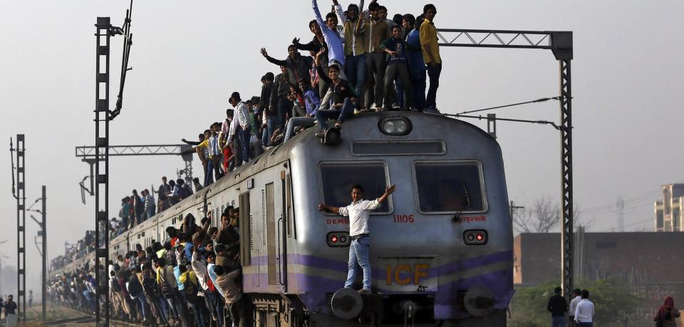 passengers-travel-on-an-overcrowded-train-on-....jpg