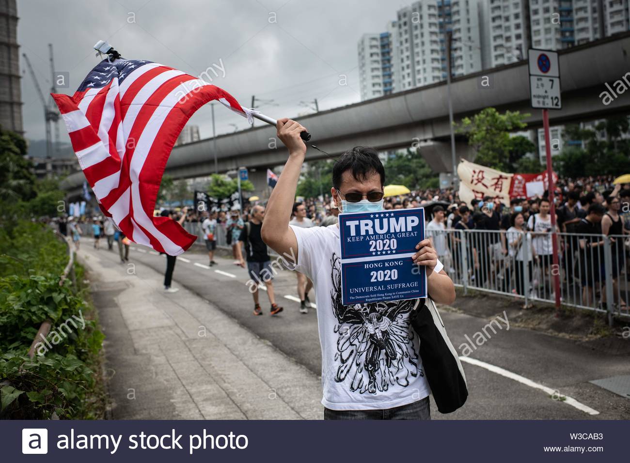 a-man-holds-an-american-flag-and-pro-trump-...